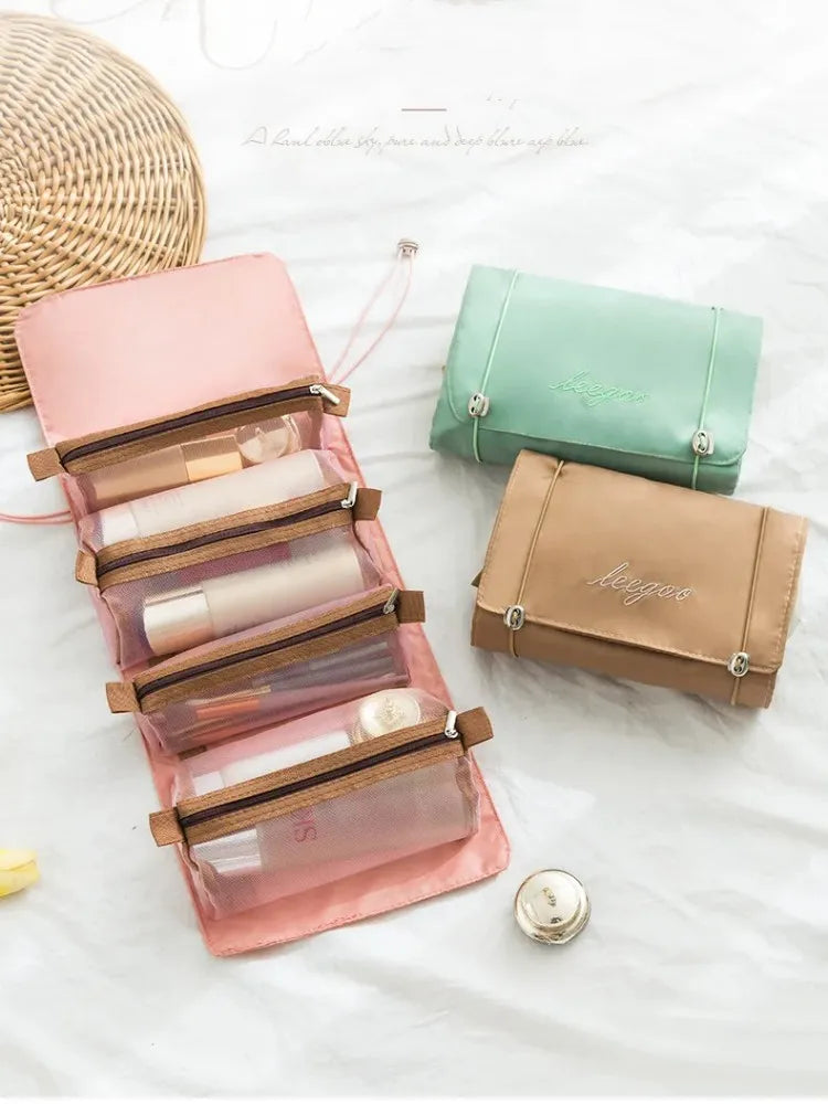 A set of portable detachable makeup bags in pink and green, with a woven straw bag nearby.