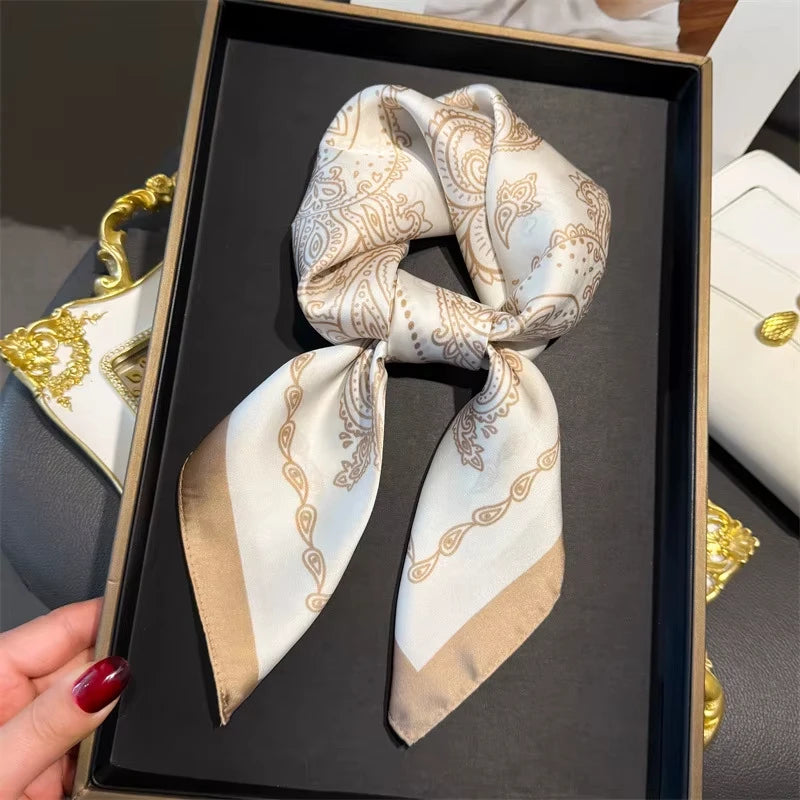 Elegant paisley silk hair scarf and headband tied in a bow displayed in a black box.