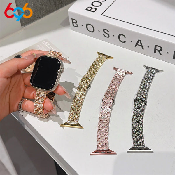 A hand displays a crystal fishscale apple watch band with sparkling metal strap on a black Apple Watch.