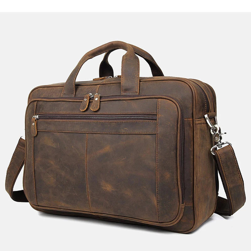 A brown genuine leather briefcase with a top handle and multiple compartments.