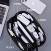 A black leather multi-layer cable organizer pouch showing various electronic cables and connectors organized inside.