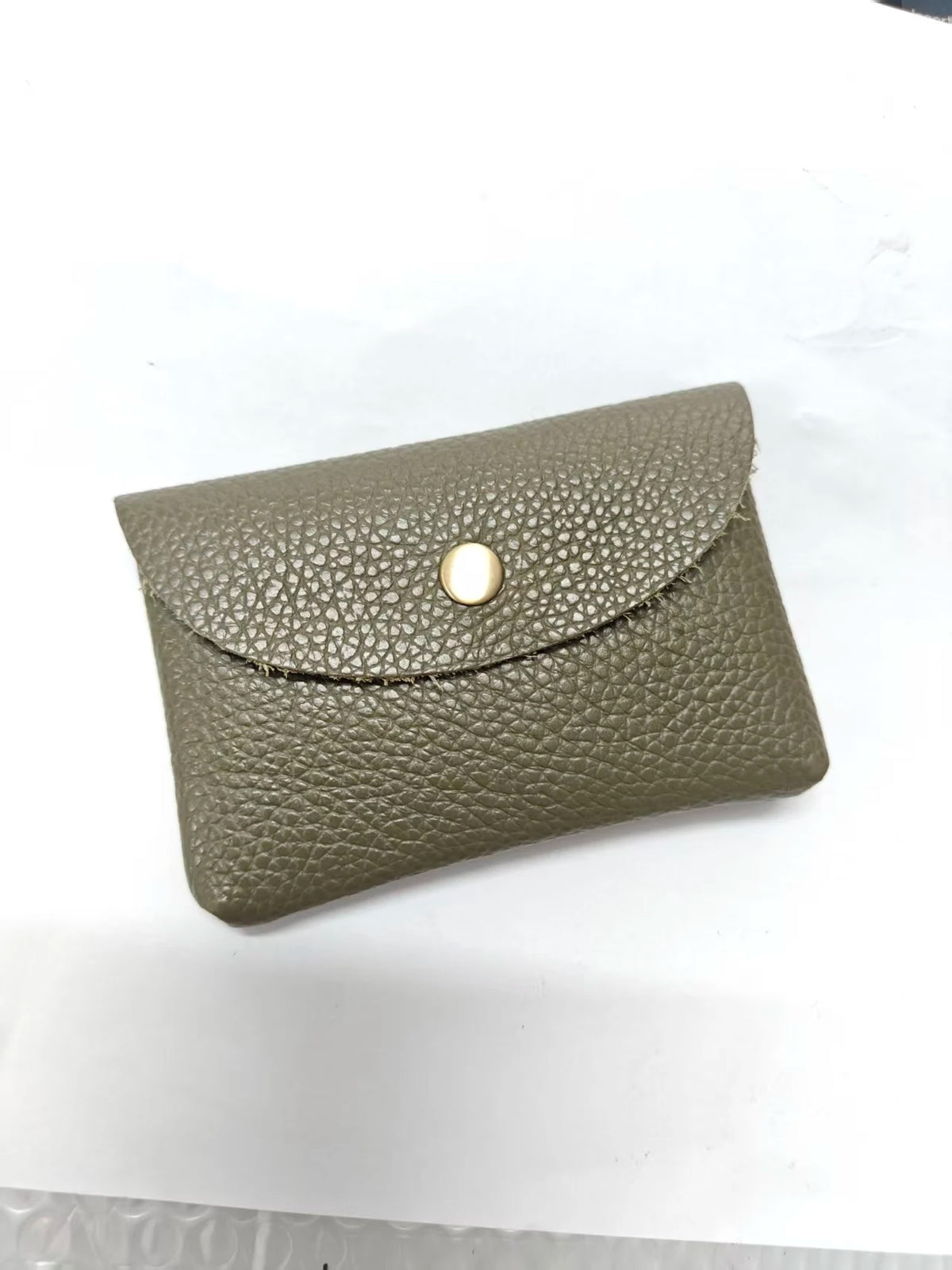 A folded olive green genuine leather card holder with a gold-toned stud closure.