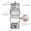A gray travel toiletry bag with a hanging hook, featuring mesh pockets and separate areas for drying and wet items.