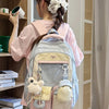 A young woman is wearing a light pink shirt and carrying a light blue backpack with yellow accents in a closet setting.