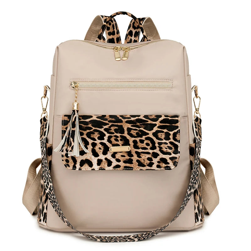 A beige fashion backpack featuring a leopard print flap and gold hardware.