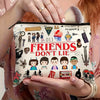 A beige zippered makeup bag featuring illustrations of friends and a title that reads Friends Don't Lie