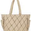 A beige quilted puffy tote bag with a handle and a zippered laptop compartment.