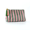 A pink and green striped cosmetic travel pouch with gold fringe.