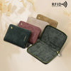 A collection of slim RFID blocking passport wallets in various muted colors, including pink, olive green, and beige.