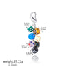 A silver keychain charm featuring several colorful dice attached to a loop.