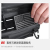 Close-up of a black tactical chest bag showing an American flag patch on the exterior.