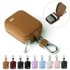 A collection of small protective cases for earphones in various colors and finishes.