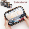 A hand holds a leopard print clear cosmetic bag filled with makeup brushes and skincare products.