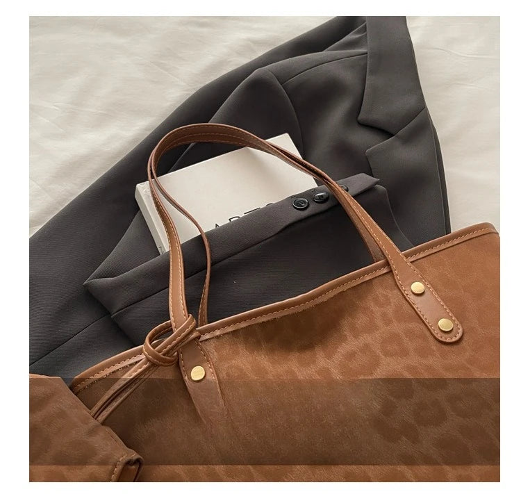 A brown leopard print tote bag is shown next to a gray blazer or jacket.