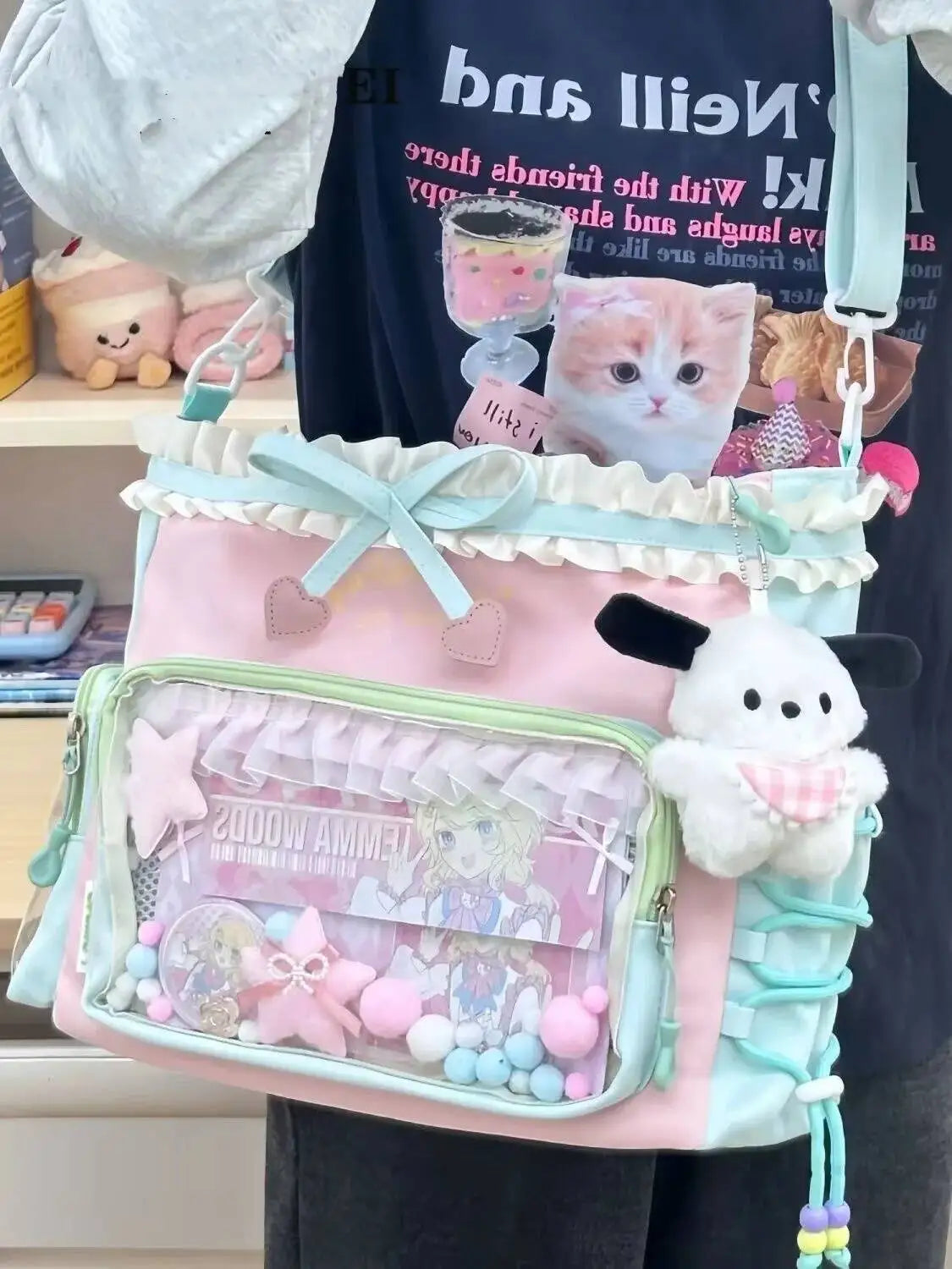 A pink and teal Y2K aesthetic transparent shoulder tote bag decorated with cat and bunny charms.