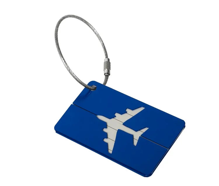 A blue aluminum luggage tag with a white airplane silhouette attached to a silver cord.