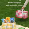 A red and white checkered picnic bag filled with snacks and a green bottle, set on a yellow checkered cloth.