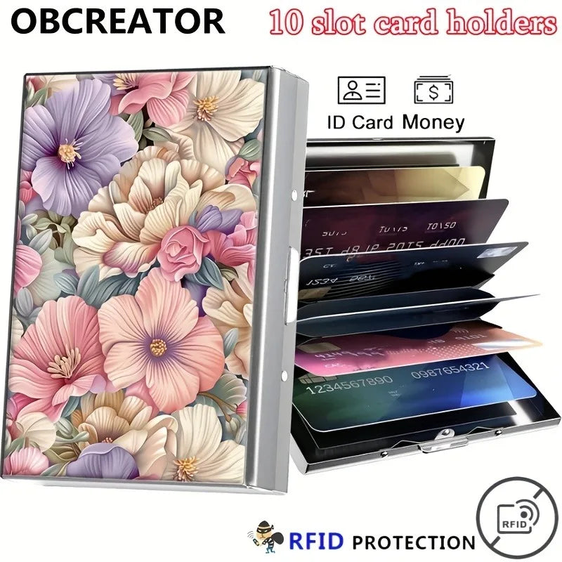 A metal card holder with a floral design featuring pink and purple flowers, displaying various cards and money.