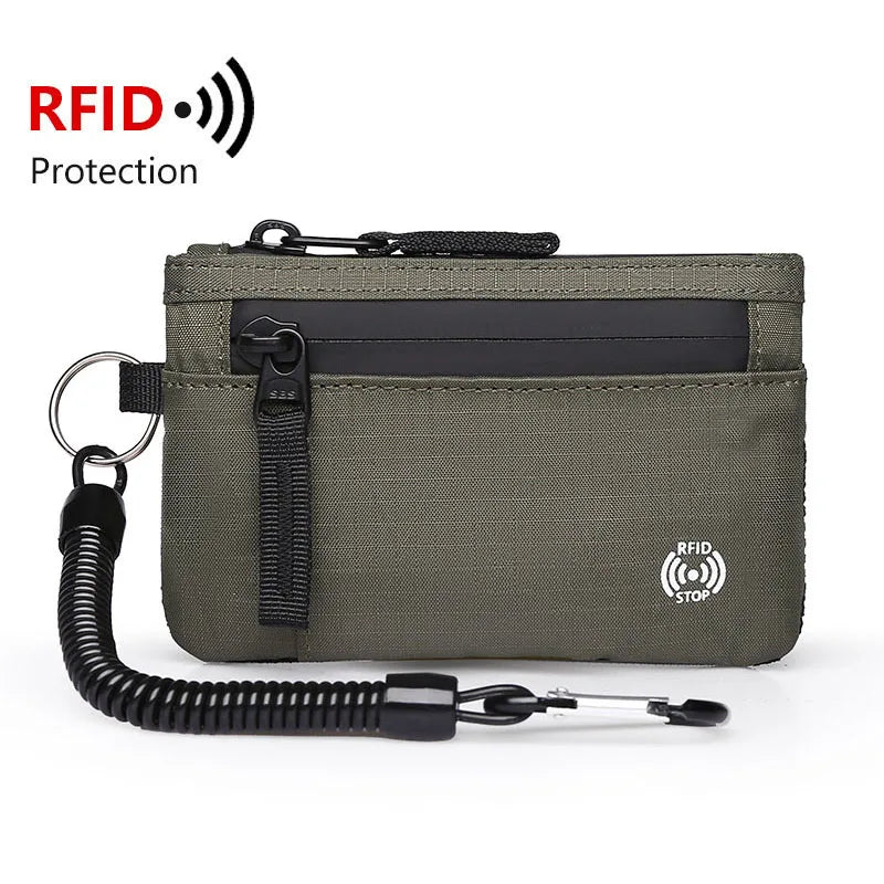A dark olive green RFID blocking travel wallet with a carabiner attached.