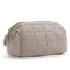 A light taupe padded makeup bag with a wide-open design and gold zipper detail.