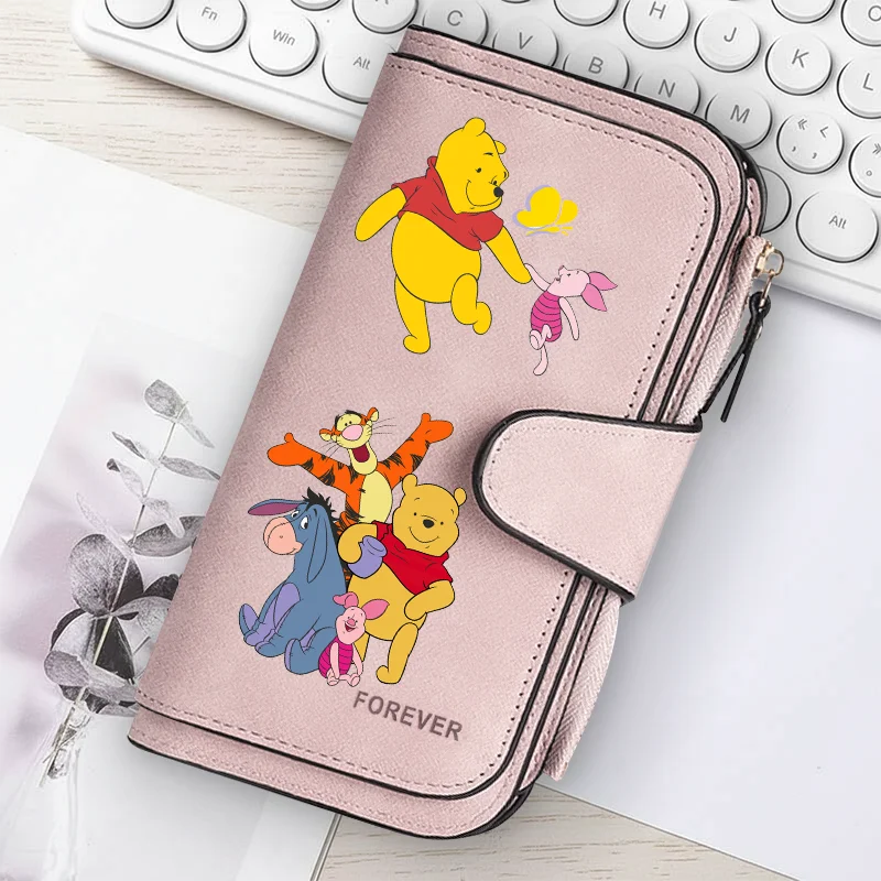 A pink women's long zipper handbag coin purse featuring illustrations of Winnie the Pooh and Piglet.