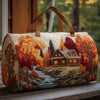 A quilted travel duffle bag featuring a detailed autumn forest scene with vibrant orange and red foliage.