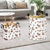 A white fabric storage basket with handles decorated with woodland animal silhouettes on a light gray rug.