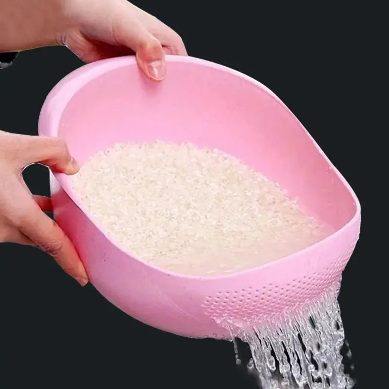 A hand is pouring white granular material from a pink plastic drain and storage basket.