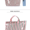 A pink and green striped tote bag is shown next to a smartphone.