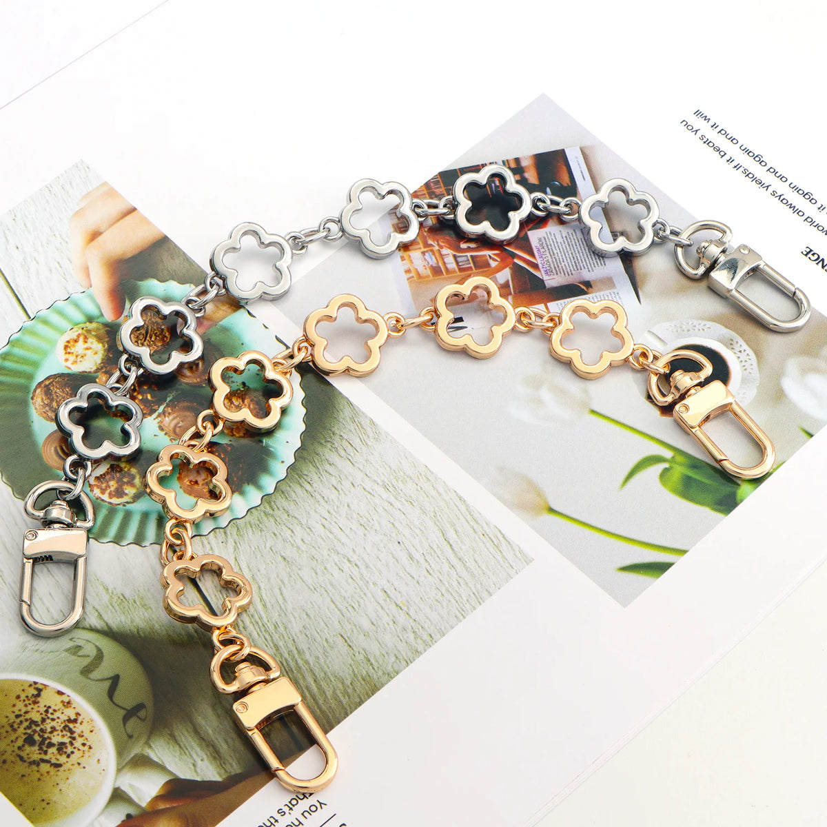 Gold and silver flower-shaped extender chain for handbags displayed on a magazine page.