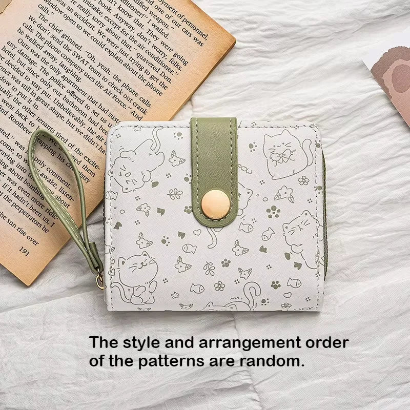 A light gray coin purse featuring a pattern of various cute cat cartoon illustrations.