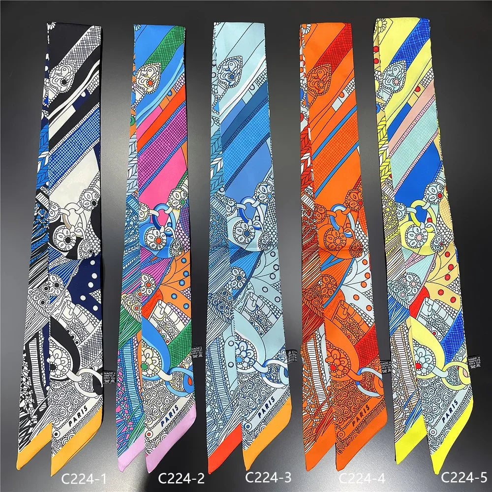 A collection of five silk twill ribbon scarves in various patterns and colors displayed vertically.