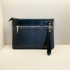 A dark blue quilted PU leather clutch bag with a black trim and gold hardware.