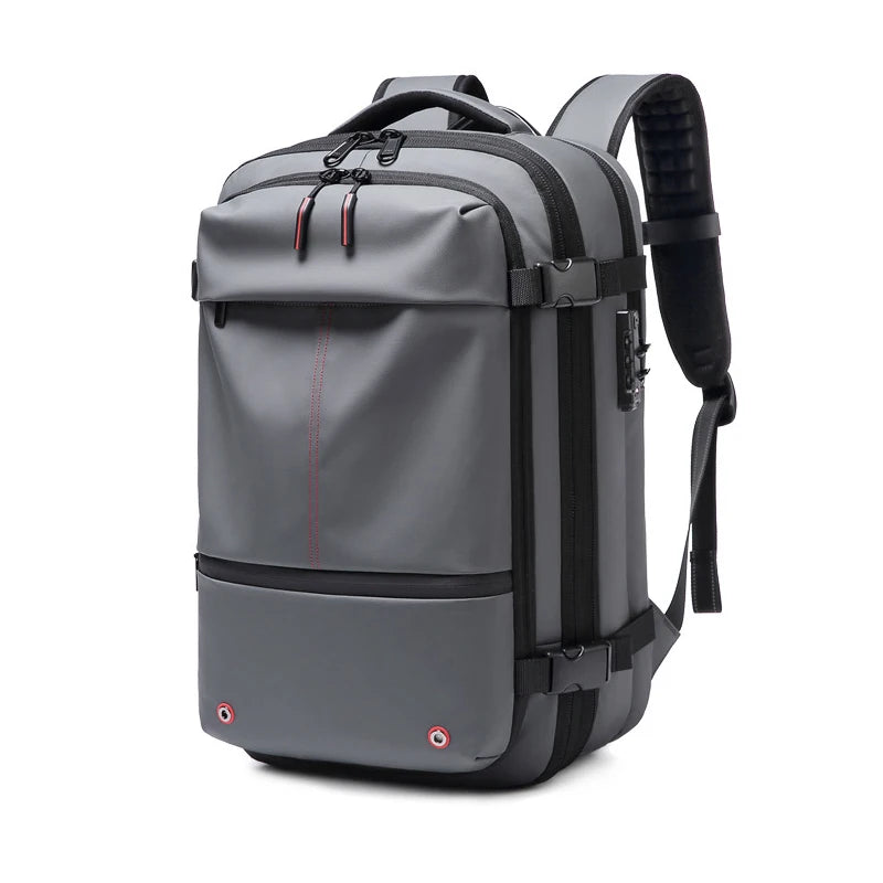 A gray heavy duty laptop backpack featuring vacuum compression and padded straps.