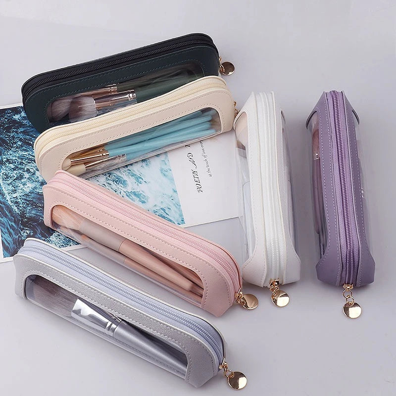 A collection of pastel cosmetic organizer pouches in various shades including pink, lavender, and white, holding makeup brush