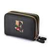 Black faux leather mini wallet with a gold letter F print and a double zipper.