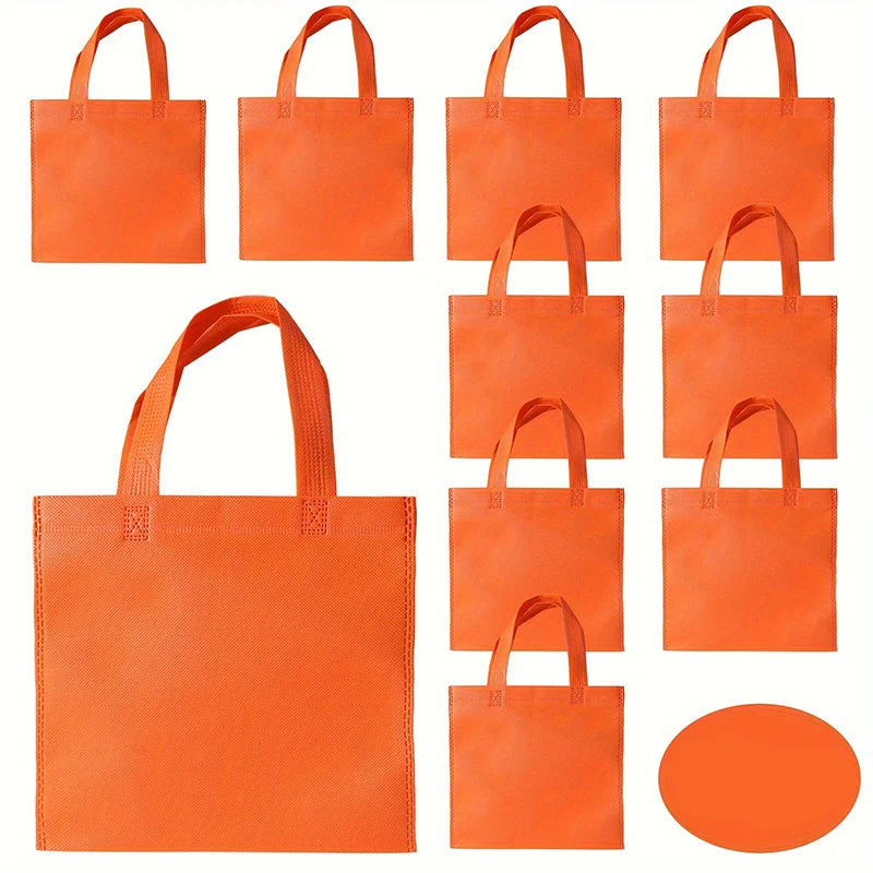A set of bright orange non-woven tote bags with handles shown in various sizes.