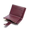 A deep burgundy leather folding wallet with gold accents shown from the side.