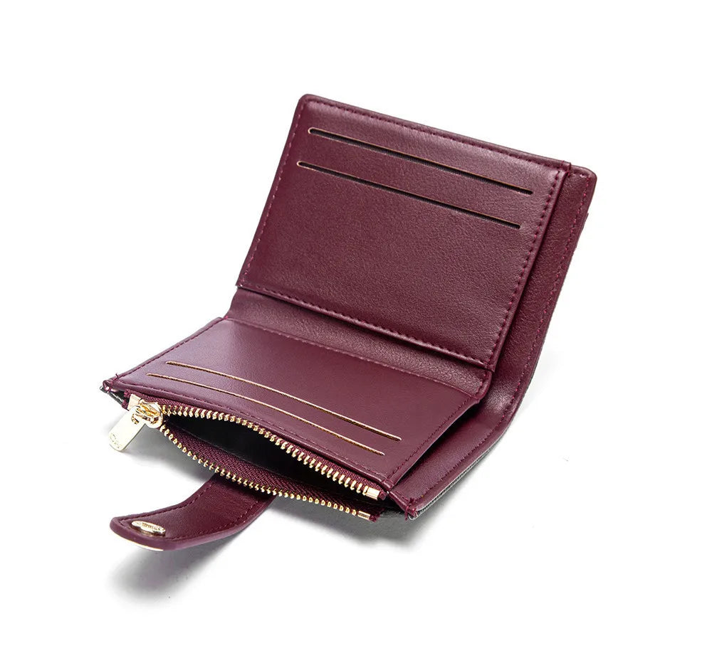 A deep burgundy leather folding wallet with gold accents shown from the side.