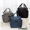 A stack of black and gray insulated canvas tote bags with double pockets displayed on a white surface.
